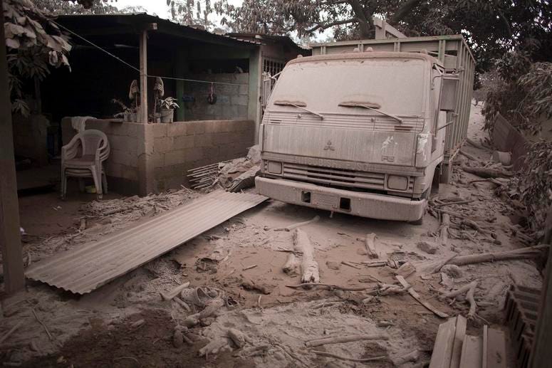 A truck is covered in volcanic ash spewed by Volcan de Fuego, or Volcano of Fire, in Escuintla, Guatemala. A truck is covered in volcanic ash spewed by Volcan de Fuego, or Volcano of Fire, in Escuintla, Guatemala.
